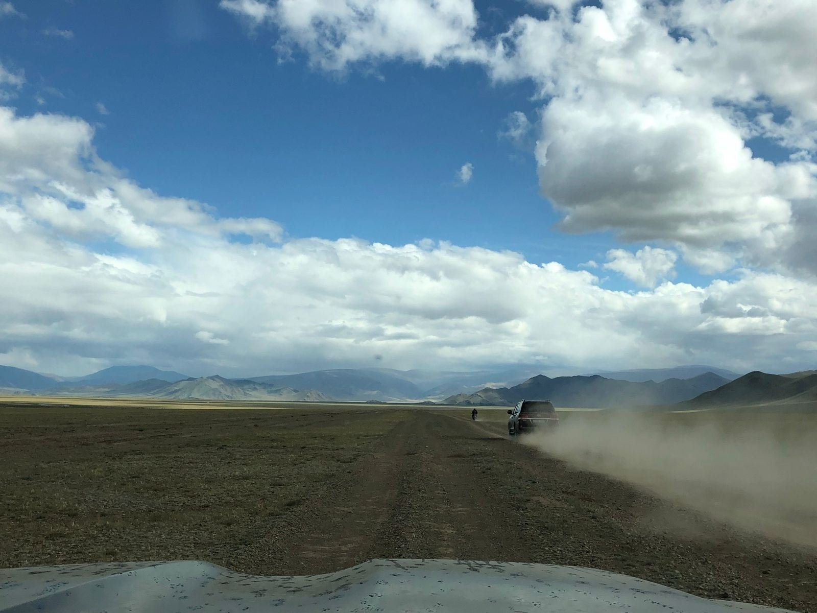 An aircraft landing on a dirt airstrip in the steppe